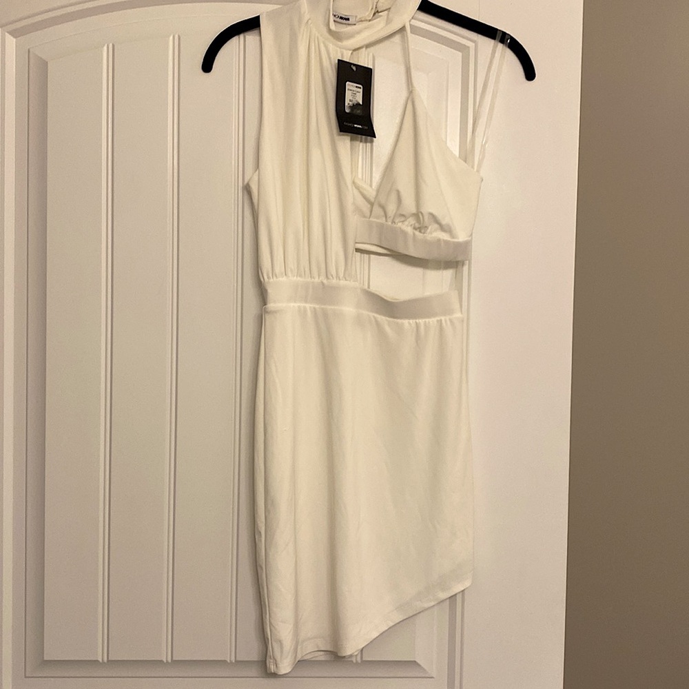 Off white cut out dress. Asymmetrical hem size XS. Still had tag